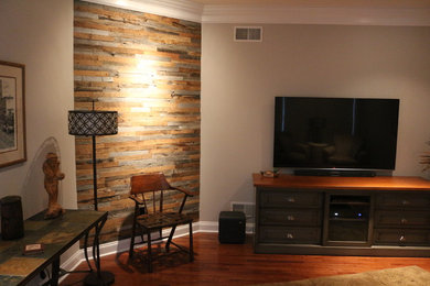Mid-sized trendy enclosed medium tone wood floor family room photo in Other with gray walls, no fireplace and a wall-mounted tv
