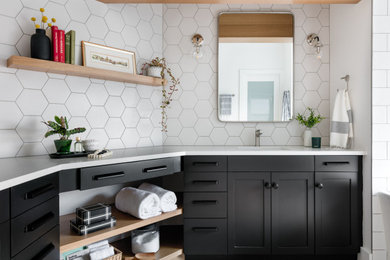 Example of a mid-sized transitional master white tile and ceramic tile cement tile floor, gray floor, double-sink, exposed beam and wainscoting bathroom design in Seattle with shaker cabinets, black cabinets, a wall-mount toilet, white walls, an undermount sink, quartz countertops, a hinged shower door, white countertops and a built-in vanity
