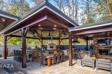 Example of a small trendy backyard stone patio kitchen design in Providence with a gazebo