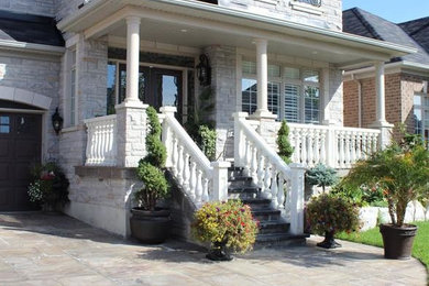 Design ideas for a large traditional full sun front yard stone driveway in Toronto.