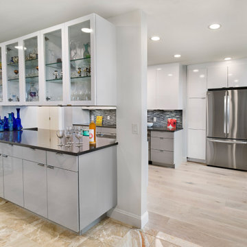 Contemporary High-Gloss Kitchen Remodel | Glass Display Cabinets & Modern Gray B