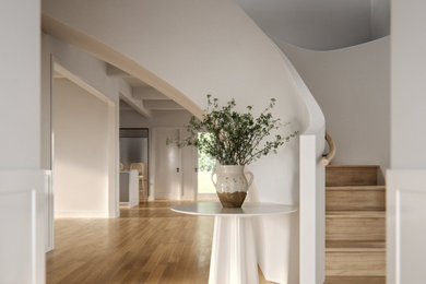 Entry hall - large contemporary light wood floor, exposed beam and wainscoting entry hall idea in Los Angeles with white walls