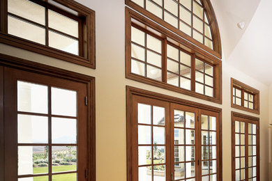 Example of a large classic formal and open concept medium tone wood floor living room design in San Luis Obispo with white walls