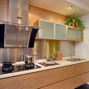Mid-sized modern kitchen pantry appliance - Example of a mid-sized minimalist single-wall vinyl floor kitchen pantry design in Singapore with a double-bowl sink, flat-panel cabinets, light wood cabinets, solid surface countertops, beige backsplash, stainless steel appliances and no island