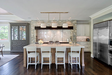 Mid-sized transitional l-shaped dark wood floor and brown floor open concept kitchen photo in Chicago with an undermount sink, recessed-panel cabinets, white cabinets, quartz countertops, gray backsplash, porcelain backsplash, stainless steel appliances and an island