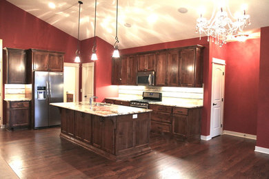 Inspiration for a timeless eat-in kitchen remodel in Minneapolis with an undermount sink, flat-panel cabinets, medium tone wood cabinets, granite countertops, beige backsplash, subway tile backsplash and stainless steel appliances