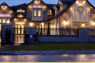 Example of a two-story stone exterior home design in Vancouver