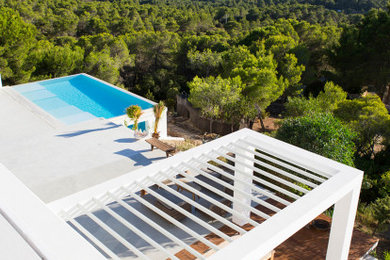 Großer Moderner Infinity-Pool hinter dem Haus in rechteckiger Form mit Betonboden in Palma de Mallorca