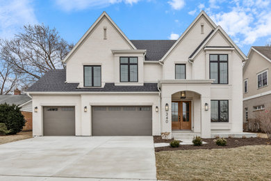 Large transitional white two-story brick and clapboard exterior home photo in Chicago with a shingle roof and a black roof