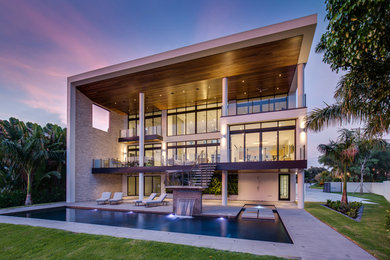 Large contemporary white two-story concrete exterior home idea in Tampa