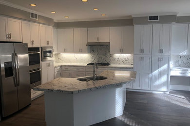 Inspiration for a timeless porcelain tile eat-in kitchen remodel in Orange County with shaker cabinets, white cabinets, quartzite countertops, an island and gray countertops