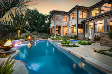 Pool - large mediterranean backyard custom-shaped pool idea in Houston with decking