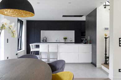 Modern eat-in kitchen in Paris with an undermount sink, recessed-panel cabinets, dark wood cabinets, quartz benchtops, white splashback, stainless steel appliances, ceramic floors, with island and white floor.