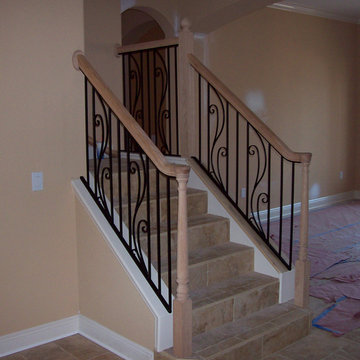 Custom wrought iron steel stair rail with spring flower design and wood cap