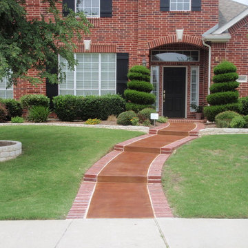 Stone borders, brick edge & stained concrete sidewalk
