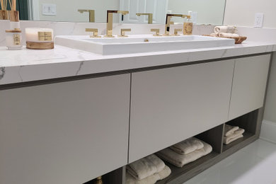 Example of a minimalist single-sink bathroom design in Boston with flat-panel cabinets, beige cabinets, a vessel sink and a built-in vanity
