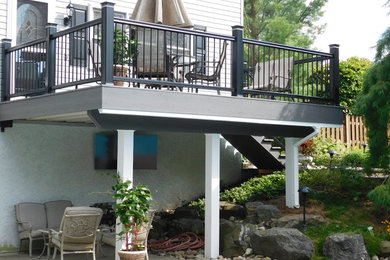 Inspiration for a mid-sized transitional backyard deck remodel in Other with no cover