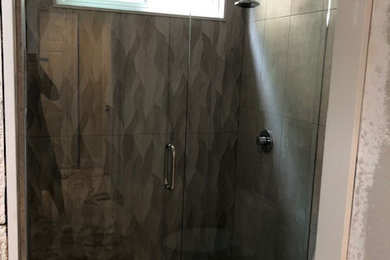 Inspiration for a bathroom remodel in Orange County with a hinged shower door