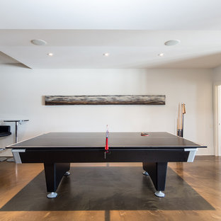 Design ideas for a large modern walk-out basement with limestone flooring, white walls and a ribbon fireplace.