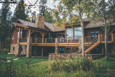 Inspiration for a large rustic brown two-story wood exterior home remodel in Other with a shingle roof