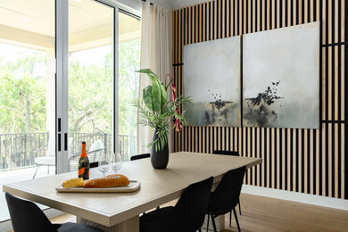 Example of a large trendy light wood floor and vaulted ceiling kitchen/dining room combo design in Austin with black walls