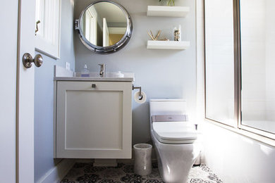 Mid-sized beach style 3/4 bathroom in Milwaukee with recessed-panel cabinets, white cabinets, an alcove shower, a one-piece toilet, grey walls, an undermount sink, multi-coloured floor, a sliding shower screen, grey benchtops and porcelain floors.