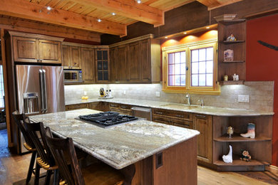 Example of a mid-sized mountain style l-shaped dark wood floor and brown floor open concept kitchen design in Vancouver with an undermount sink, raised-panel cabinets, dark wood cabinets, stainless steel appliances and an island