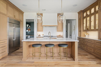 Example of a mid-sized transitional light wood floor kitchen pantry design in Kansas City with an undermount sink, beaded inset cabinets, light wood cabinets, quartz countertops, subway tile backsplash, stainless steel appliances, an island and white countertops