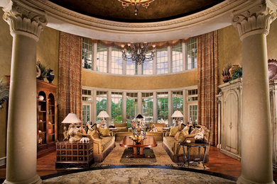 This is an example of a large mediterranean enclosed living room in Atlanta with beige walls and medium hardwood floors.