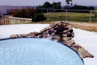 Backyard concrete and kidney-shaped pool fountain photo in DC Metro