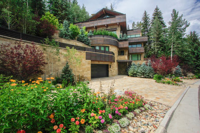 Inspiration for a front yard stone driveway in Denver.
