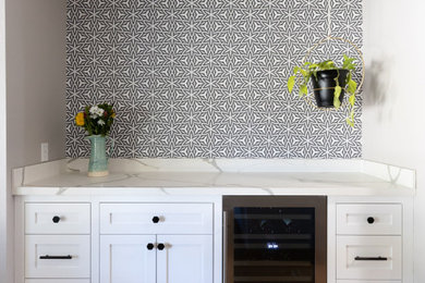 Inspiration for a small coastal light wood floor, brown floor and wallpaper kitchen/dining room combo remodel in Phoenix with white walls