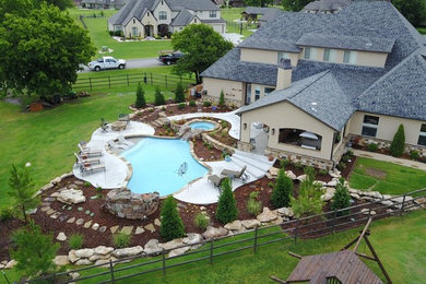Inspiration for a rustic backyard concrete paver and custom-shaped lap hot tub remodel in Other