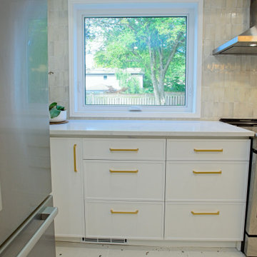 White Kitchen Drawers Beneath a Bright Garden Window | Etobicoke