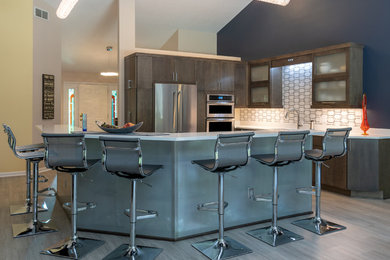 Inspiration for a mid-sized modern l-shaped porcelain tile and gray floor eat-in kitchen remodel in Other with an undermount sink, flat-panel cabinets, brown cabinets, quartz countertops, multicolored backsplash, marble backsplash, stainless steel appliances, an island and white countertops