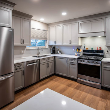 Two-Tone Neutral Kitchen with Quartz Countertop and Soho Picket Backsplash