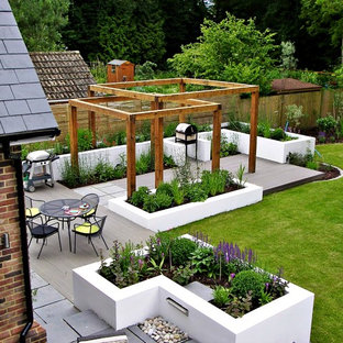 Photo of a contemporary backyard garden in London with decking and with raised garden bed.