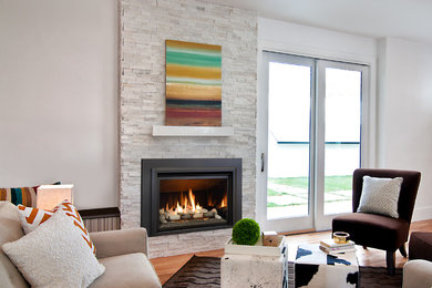 Example of a large trendy formal and enclosed dark wood floor living room design in Minneapolis with white walls, a standard fireplace, a stone fireplace and no tv