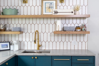 Home bar - modern l-shaped home bar idea in San Francisco with an undermount sink, flat-panel cabinets, blue cabinets and white backsplash