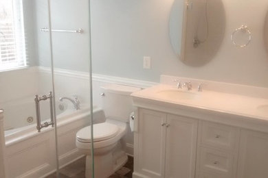 Example of a small minimalist master white tile and ceramic tile ceramic tile bathroom design in DC Metro with furniture-like cabinets, white cabinets, a two-piece toilet, green walls, an integrated sink and quartz countertops