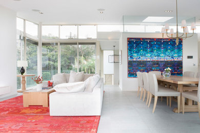 Photo of a mid-sized contemporary open plan dining in Sydney with white walls, porcelain floors, no fireplace and white floor.
