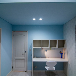 Design ideas for a modern home office and library in Other with blue walls, painted wood flooring, a freestanding desk and grey floors.