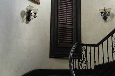 Staircase - large mediterranean wooden curved metal railing staircase idea with tile risers