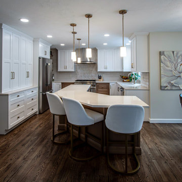 Two Tone Kitchen with Floating Shelves and Island Seating and Updated Fireplace