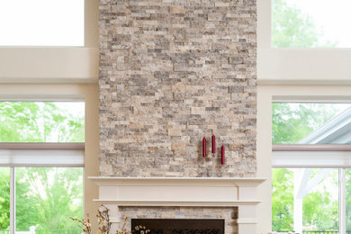 Inspiration for a family room remodel in Denver with beige walls, a standard fireplace and a brick fireplace