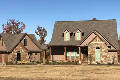 Mid-sized elegant brown two-story mixed siding exterior home photo in Other with a shingle roof