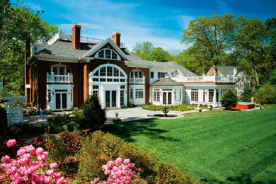 Inspiration for a large timeless red three-story brick exterior home remodel in Boston with a clipped gable roof