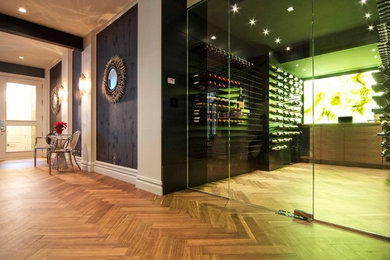 Inspiration for a mid-sized modern wine cellar in New York with light hardwood floors and storage racks.