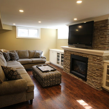 Basement recreation room with new stone fireplace and built-ins