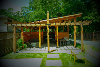 Example of a mid-sized urban backyard concrete patio design in Atlanta with a pergola